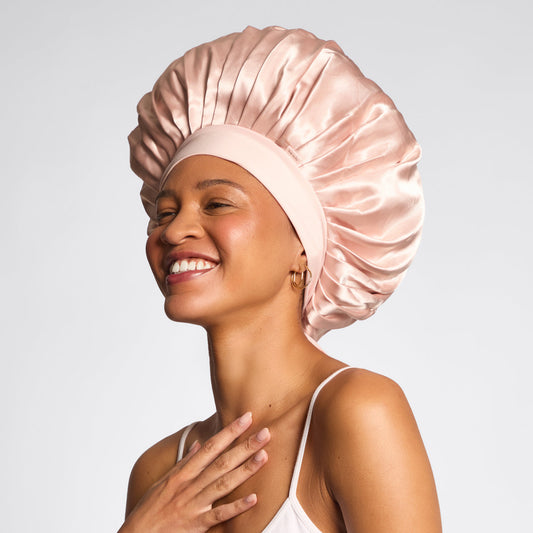 KITSCH Blush Oversized Satin Bonnet — model lifestyle shot — worn while sleeping