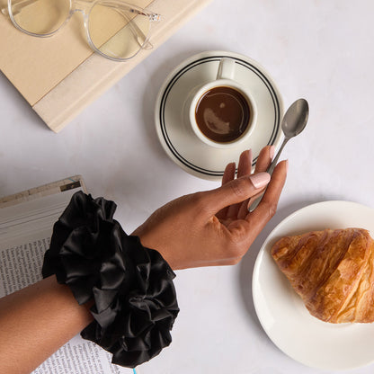 KITSCH Black Ruffle Scrunchie — model styling hair with black ruffle scrunchie — bold ruffle design for casual days, workouts, or photo-ready looks